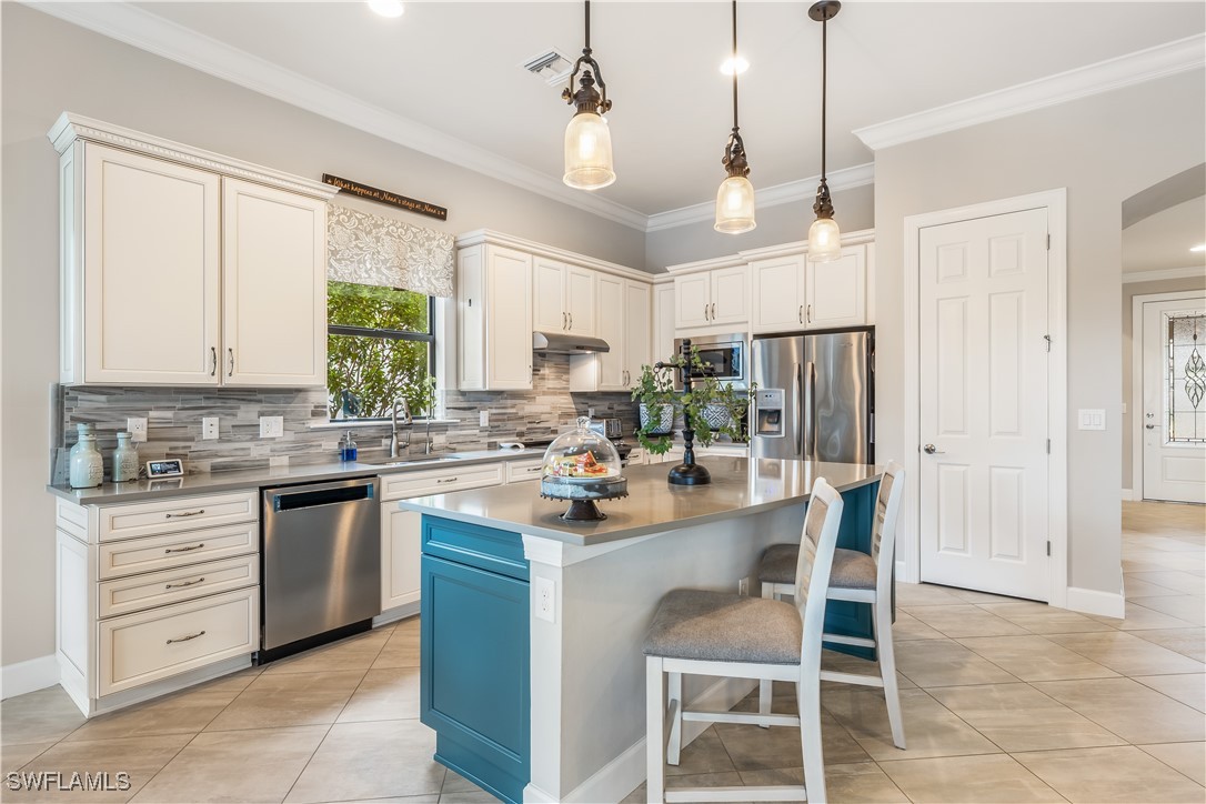 12894 Epping Way Fort Myers, FL 33913 - Photo 15 of 49 a kitchen with a sink stove cabinets and refrigerator