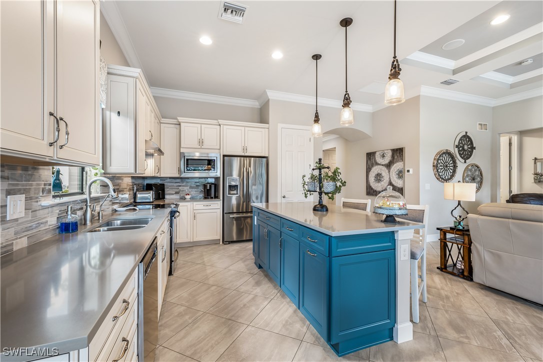 12894 Epping Way Fort Myers, FL 33913 - Photo 16 of 49 a kitchen with stainless steel appliances kitchen island granite countertop a sink a stove and a refrigerator