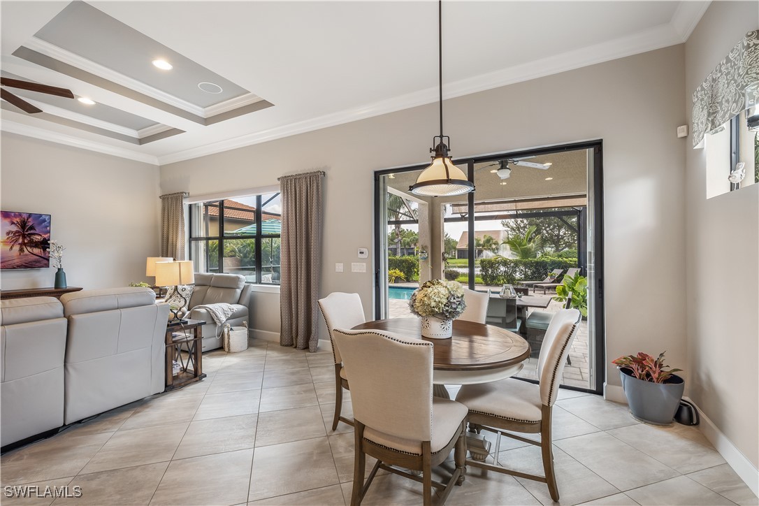 12894 Epping Way Fort Myers, FL 33913 - Photo 18 of 49 a dining room with furniture mountain view and a floor to ceiling window
