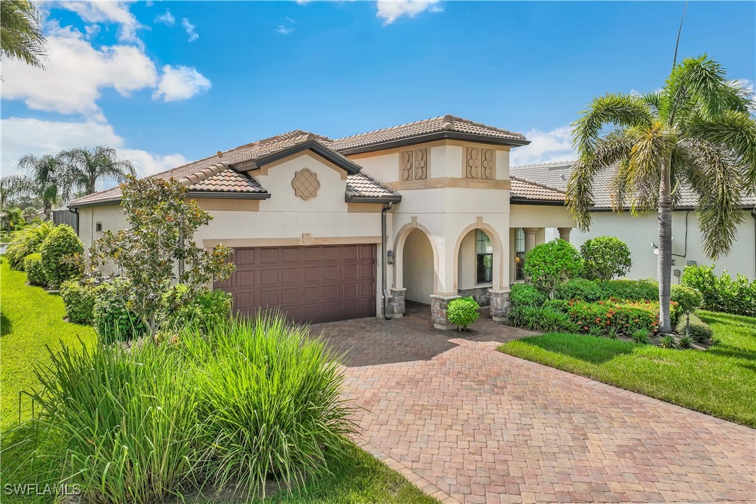12894 Epping Way Fort Myers, FL 33913 - Photo 2 of 49 a front view of a house with a garden