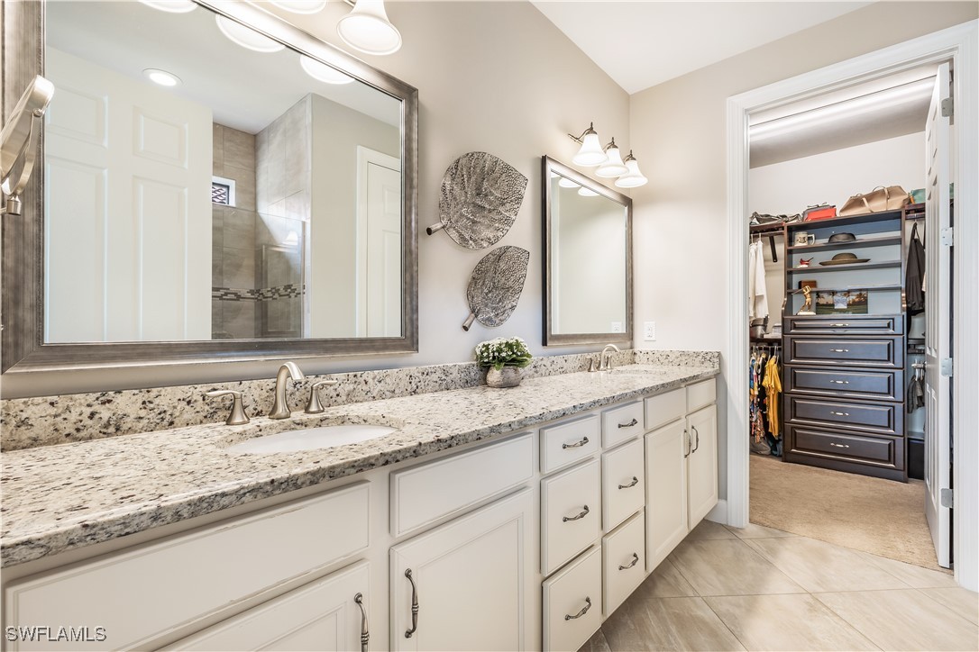 12894 Epping Way Fort Myers, FL 33913 - Photo 24 of 49 a bathroom with a granite countertop sink and a mirror