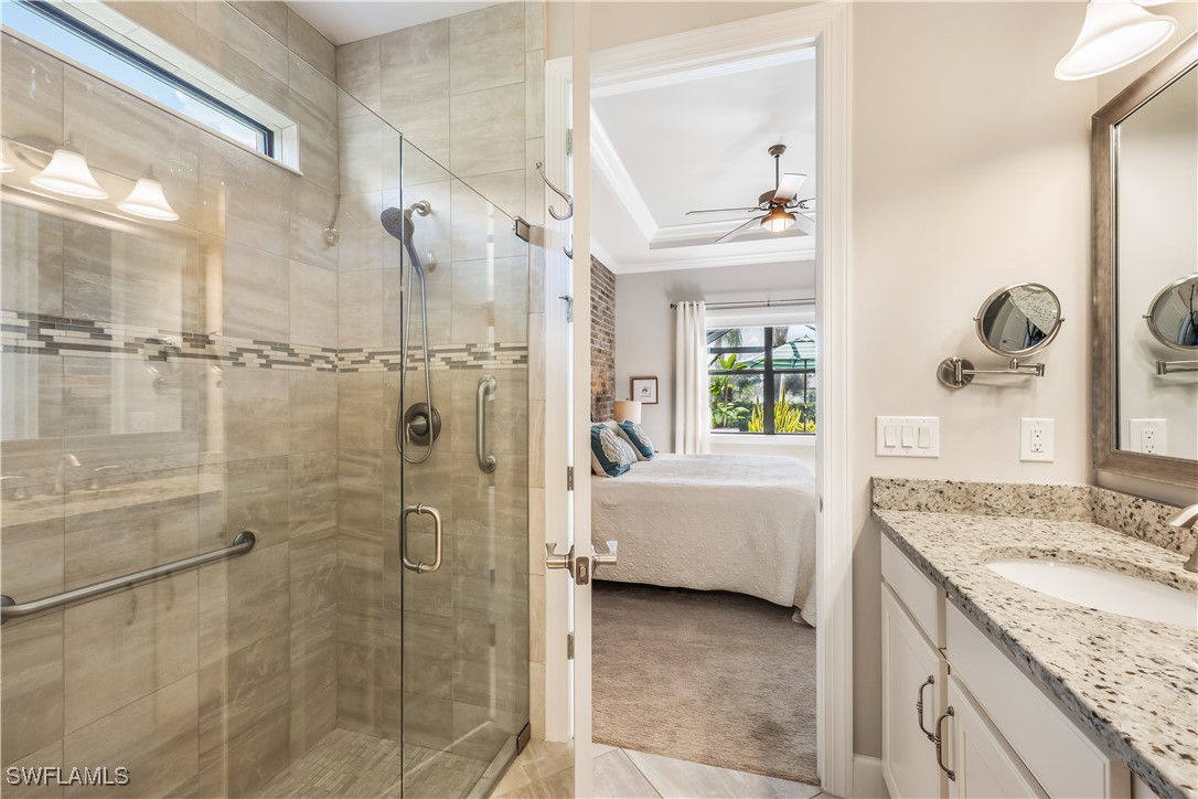 12894 Epping Way Fort Myers, FL 33913 - Photo 25 of 49 a bathroom with a granite countertop sink a mirror a bathtub and shower
