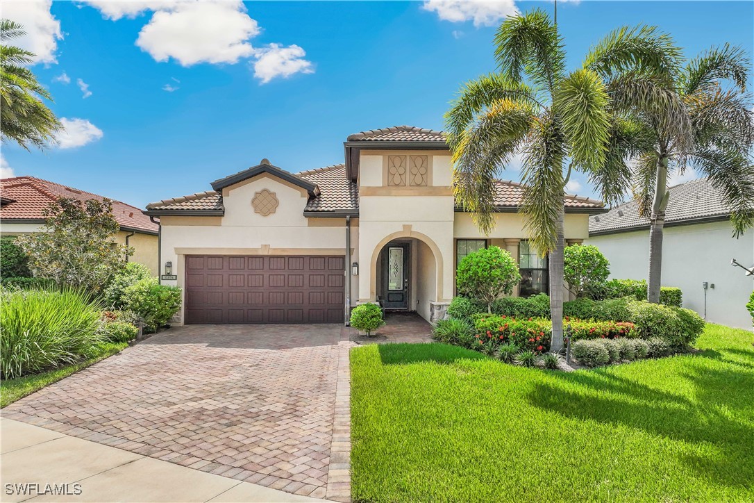 12894 Epping Way Fort Myers, FL 33913 - Photo 5 of 49 a view of a house with a small yard and palm trees