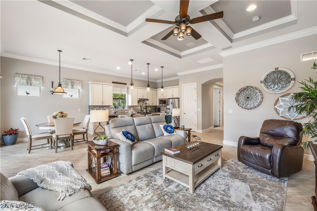12894 Epping Way Fort Myers, FL 33913 - Photo 8 of 49 a living room with furniture kitchen view and a chandelier