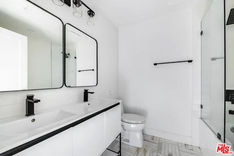 a bathroom with a sink toilet and mirror