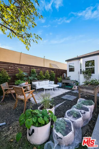 a view of a patio with couches and potted plants
