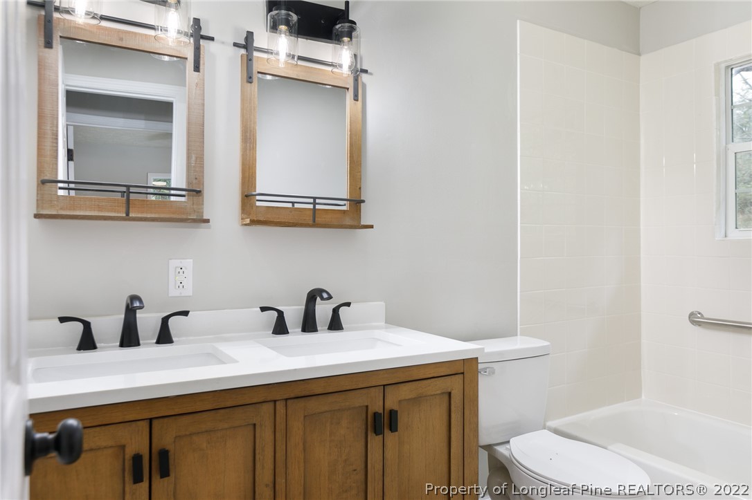 595 Midway Road Aberdeen, NC 28315 - Photo 18 of 22 a bathroom with a sink and a toilet