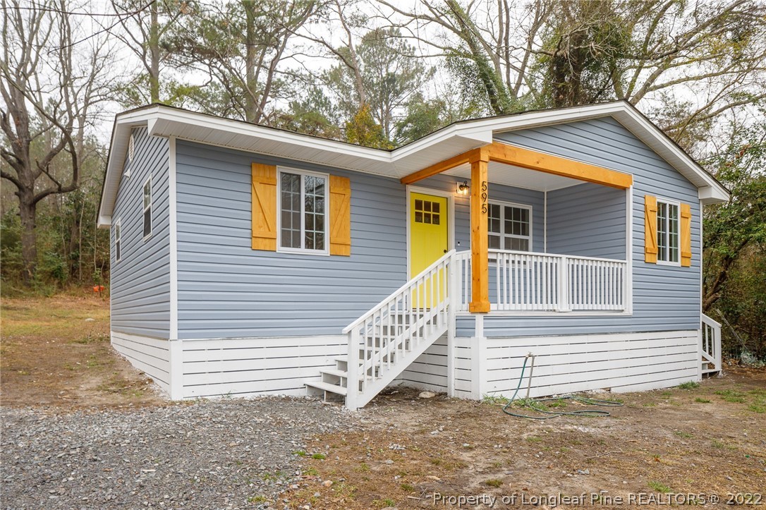 595 Midway Road Aberdeen, NC 28315 - Photo 2 of 22 a view of a house with a yard