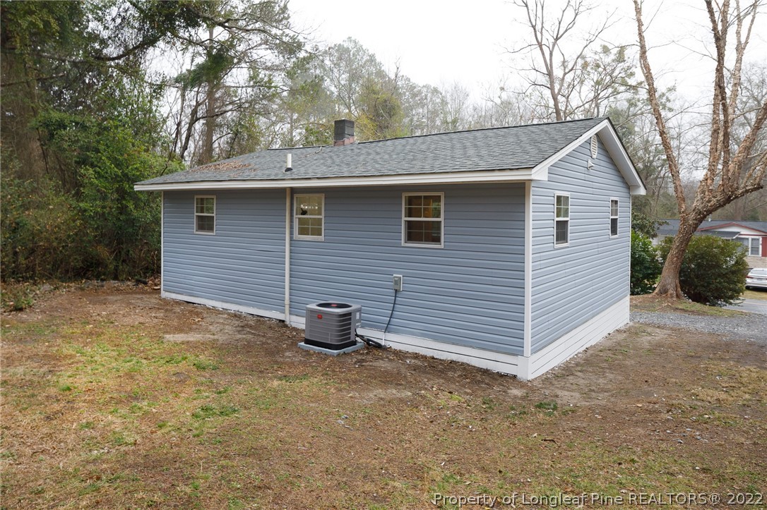 595 Midway Road Aberdeen, NC 28315 - Photo 22 of 22 a view of a house with a yard and garage