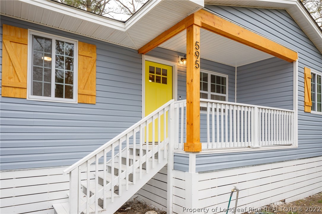 595 Midway Road Aberdeen, NC 28315 - Photo 3 of 22 a view of a house with wooden floor and a large window