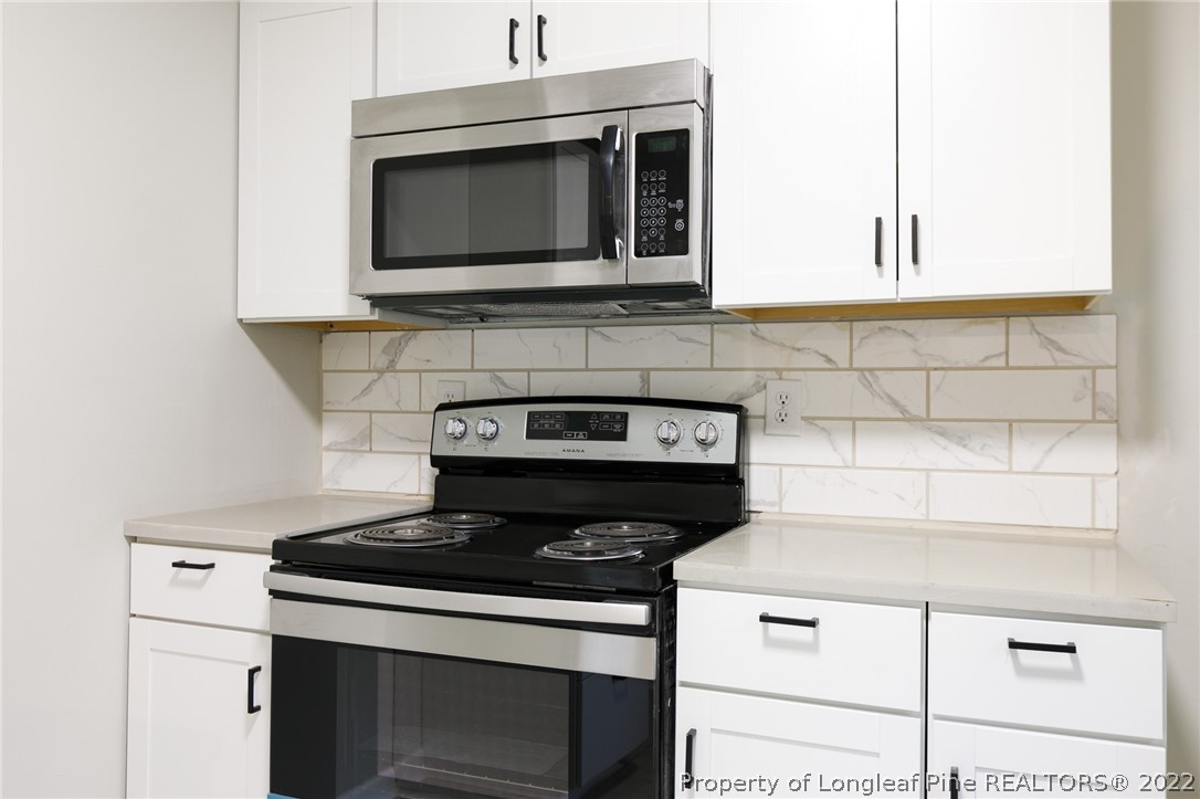 595 Midway Road Aberdeen, NC 28315 - Photo 9 of 22 a stove top oven sitting inside of a kitchen