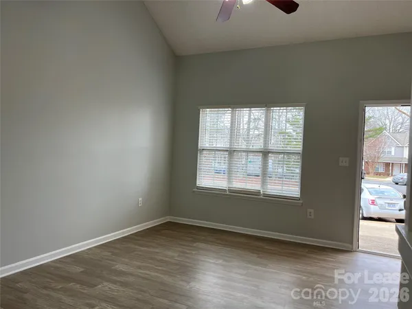 an empty room with a empty space and windows