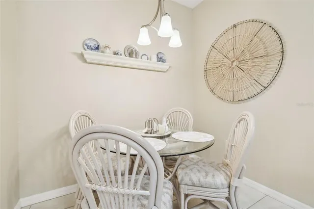 a kitchen with sink refrigerator dining table and chairs