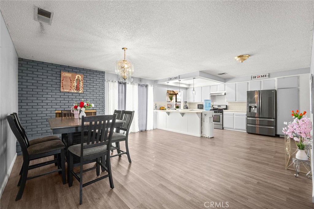 15811 Hercules Street Hesperia, CA 92345 - Photo 12 of 43 a view of a dining room with furniture and wooden floor