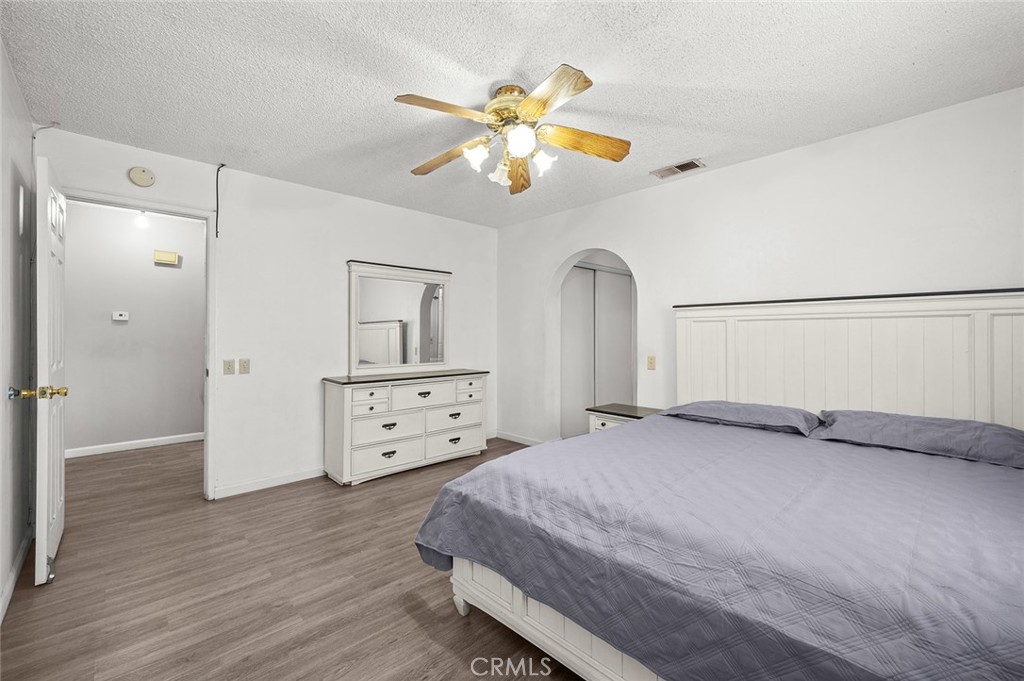 15811 Hercules Street Hesperia, CA 92345 - Photo 18 of 43 a bedroom with a bed and a chandelier