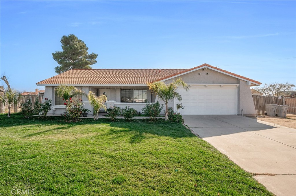 15811 Hercules Street Hesperia, CA 92345 - Photo 2 of 43 a front view of a house with garden