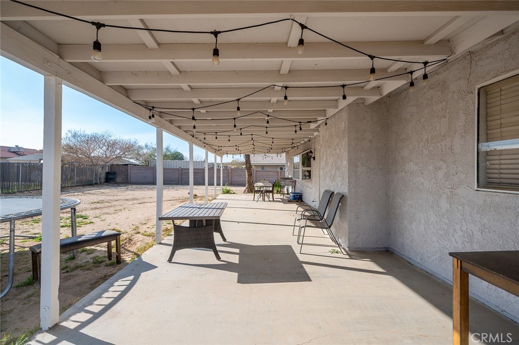 15811 Hercules Street Hesperia, CA 92345 - Photo 28 of 43 a view of a patio with a table and chairs