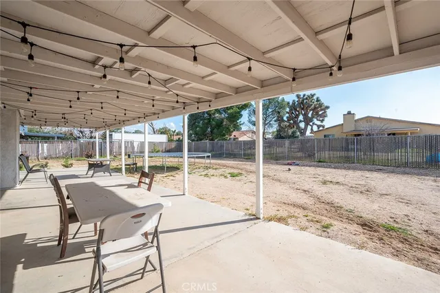 a view of a backyard with a table and chairs