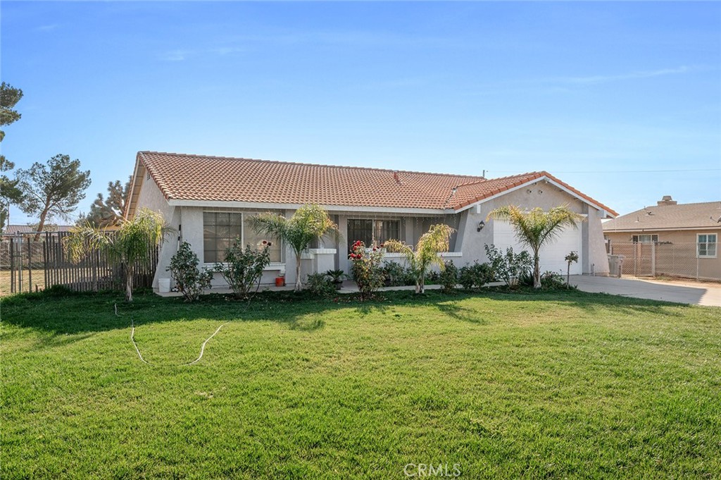 15811 Hercules Street Hesperia, CA 92345 - Photo 3 of 43 a front view of a house with garden
