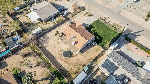 an aerial view of a house with a yard