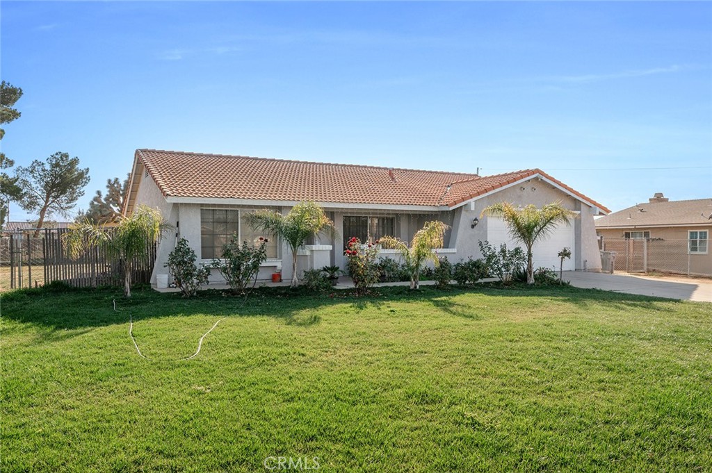 15811 Hercules Street Hesperia, CA 92345 - Photo 4 of 43 a front view of a house with garden