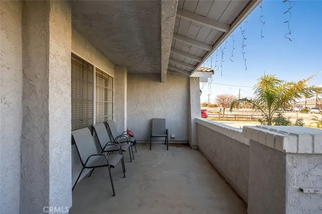 a building outdoor space with patio furniture and potted plants