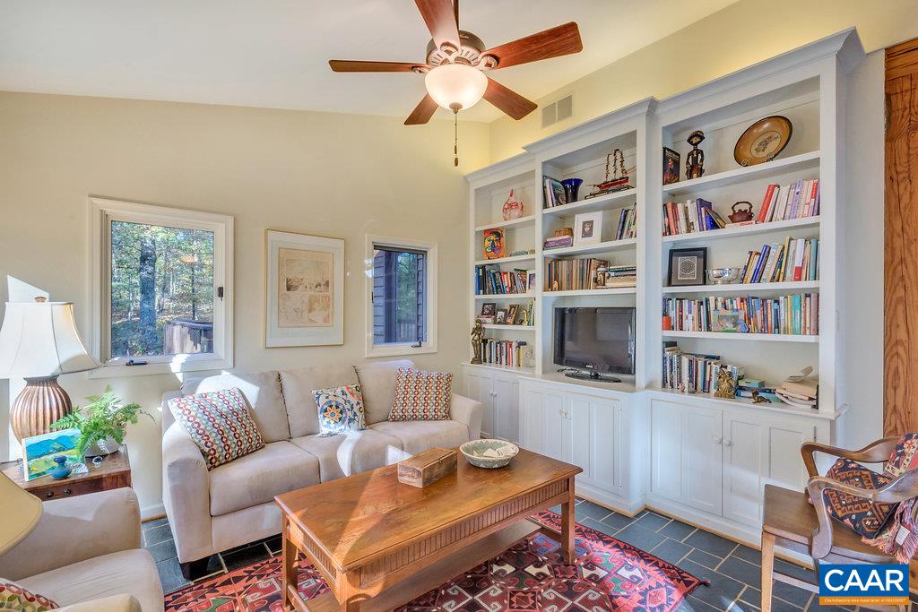 3272 Buck Island Road Charlottesville, VA 22902 - Photo 12 of 41 a living room with furniture a bookshelf and a window