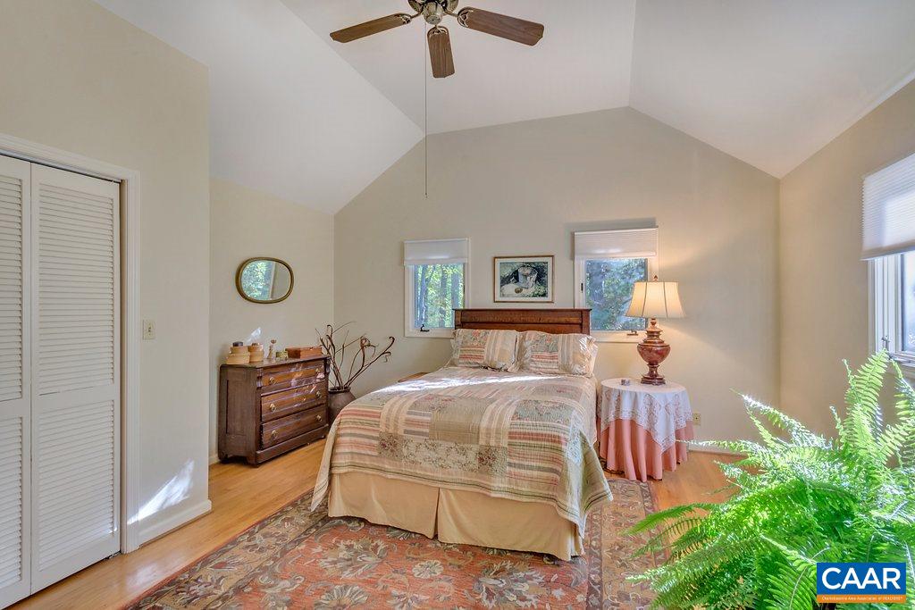 3272 Buck Island Road Charlottesville, VA 22902 - Photo 16 of 41 a bedroom with a bed and a chandelier