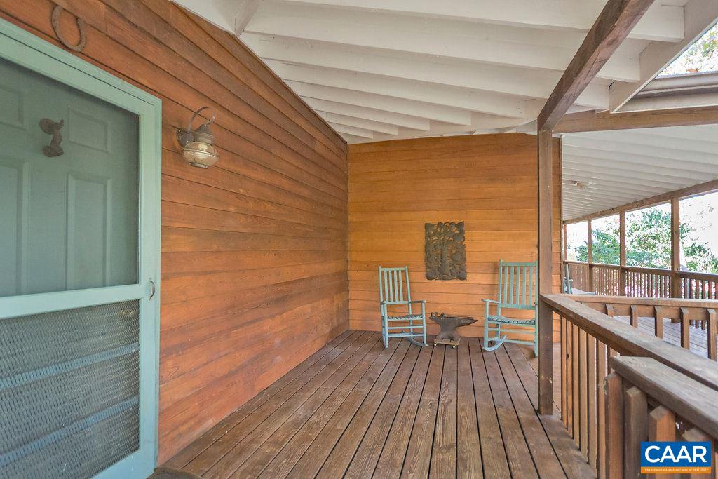 3272 Buck Island Road Charlottesville, VA 22902 - Photo 2 of 41 a view of a balcony with chairs and wooden floor