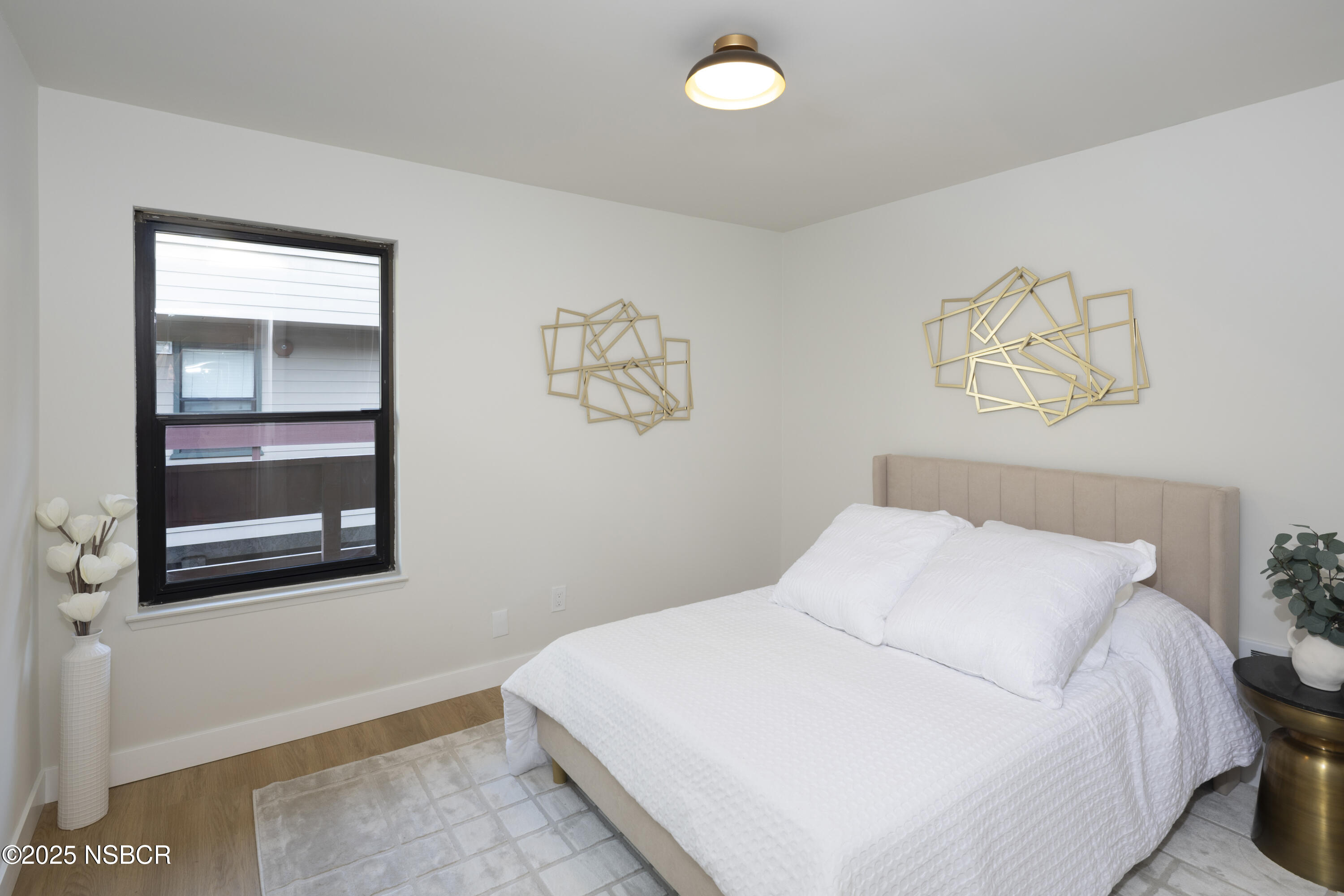 680 Chorro Street, Unit 5 San Luis Obispo, CA 93401 - Photo 12 of 24 a bedroom with a bed and a painting on the wall