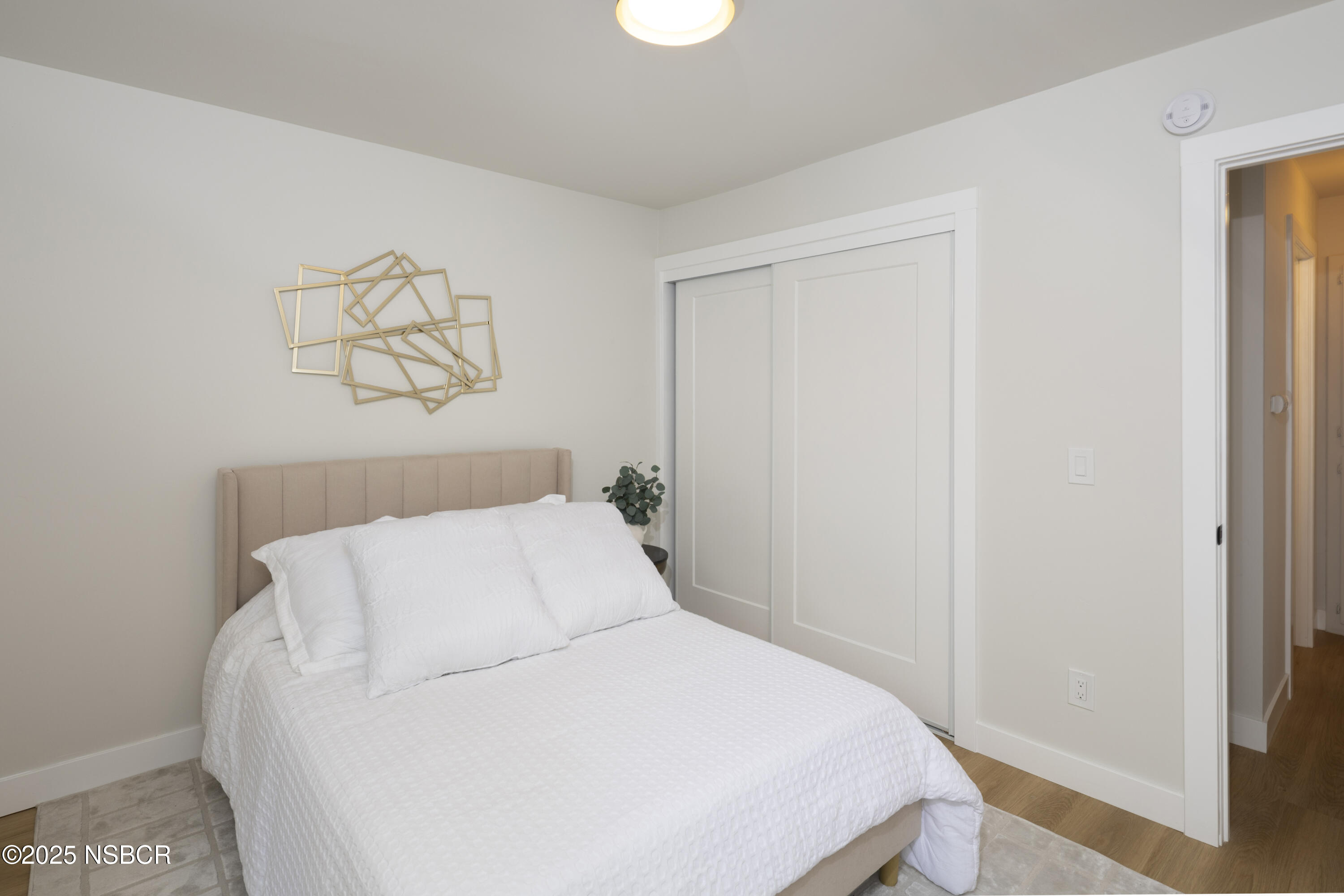 680 Chorro Street, Unit 5 San Luis Obispo, CA 93401 - Photo 13 of 24 a bedroom with a bed and painting on the wall