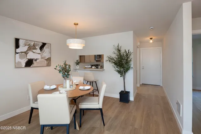 a view of a livingroom with furniture and a potted plant