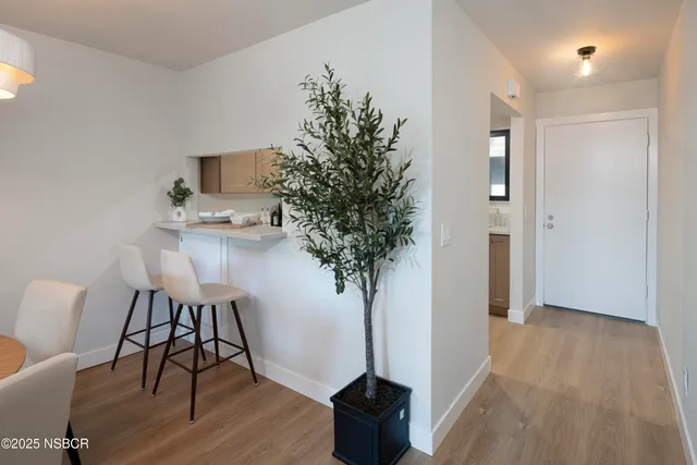 a view of a room with furniture and wooden floor