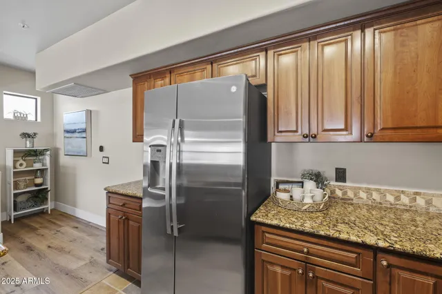 a kitchen with refrigerator cabinets dining table and chairs