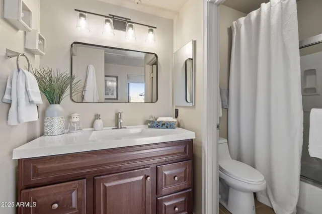 a bedroom with a bed a couch and a window