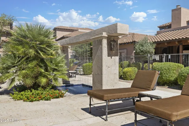 a view of a swimming pool with outdoor seating