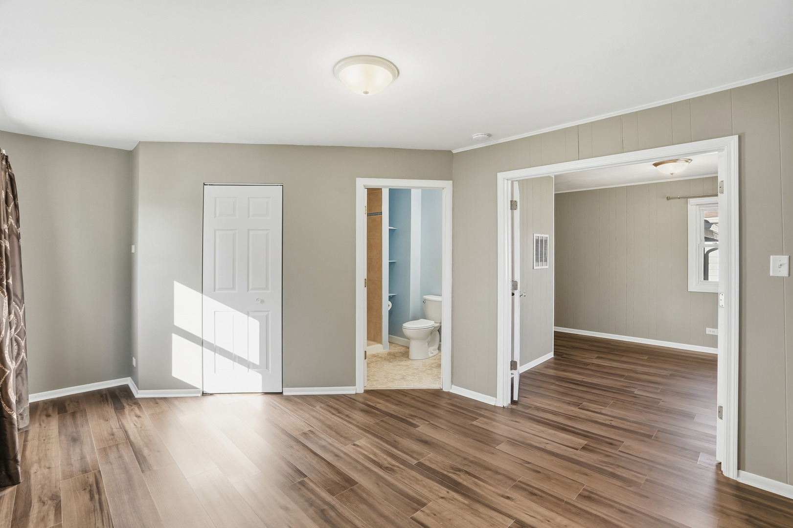 3439 Sangamon Street Steger, IL 60475 - Photo 11 of 25 an empty room with wooden floor and windows
