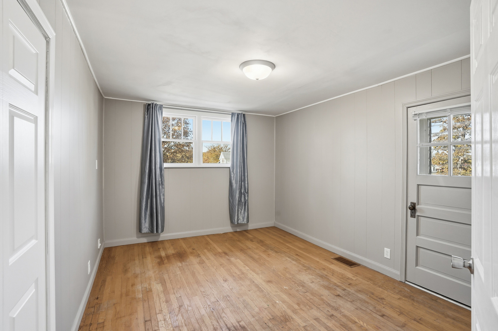 3439 Sangamon Street Steger, IL 60475 - Photo 16 of 25 an empty room with wooden floor cabinet and windows