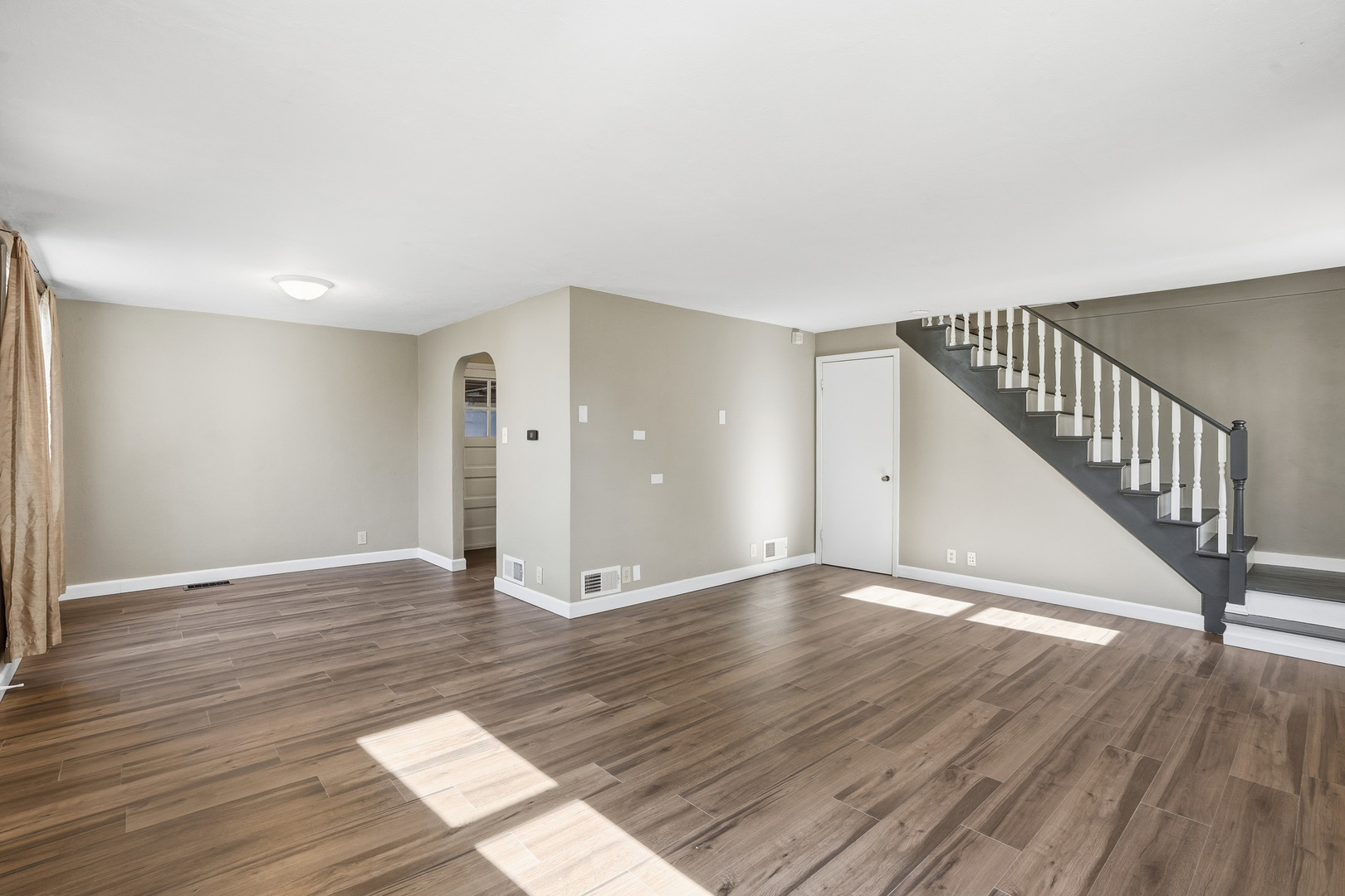 3439 Sangamon Street Steger, IL 60475 - Photo 3 of 25 a view of an empty room with wooden floor and stairs
