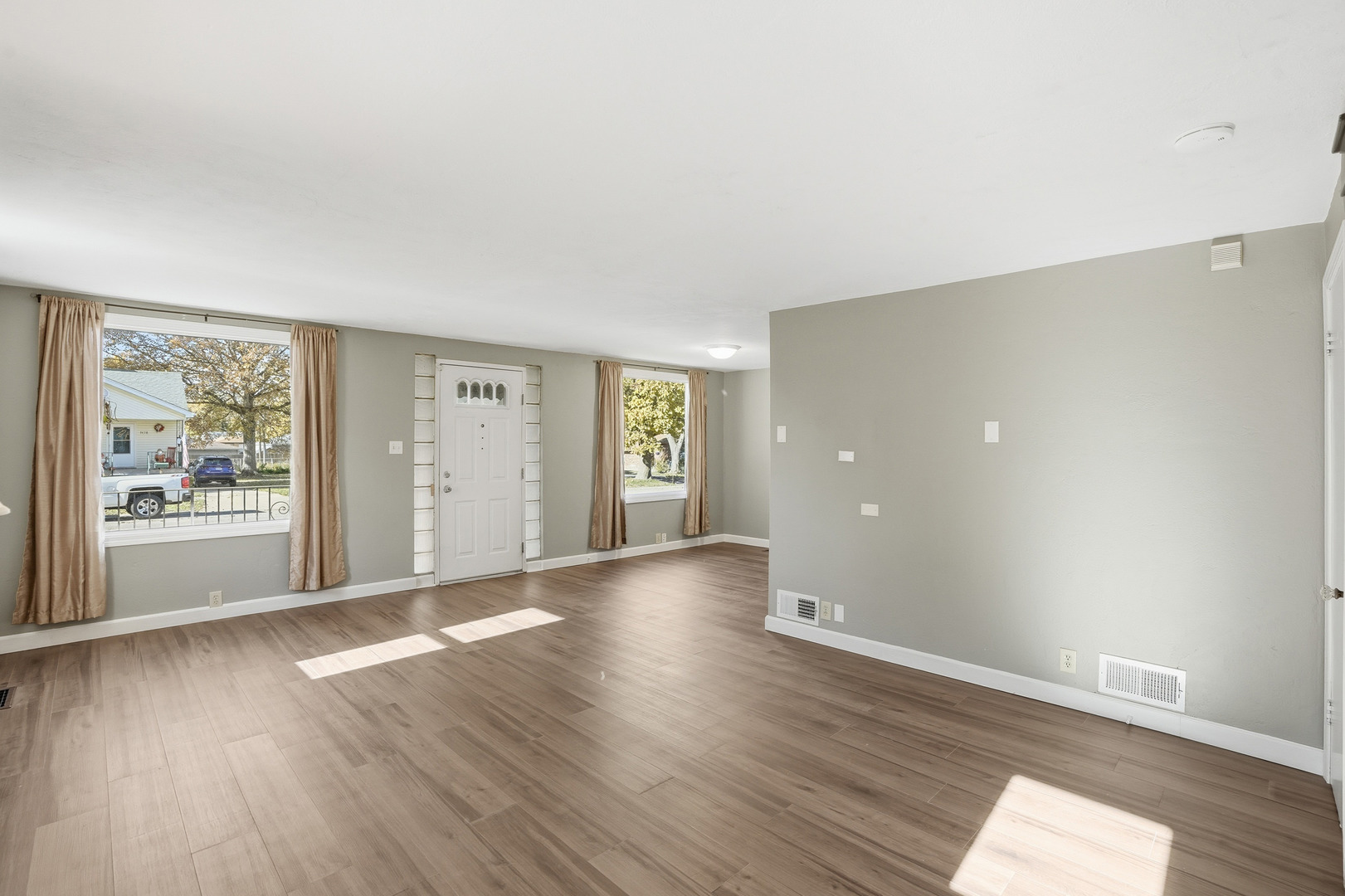 3439 Sangamon Street Steger, IL 60475 - Photo 4 of 25 an empty room with wooden floor and windows