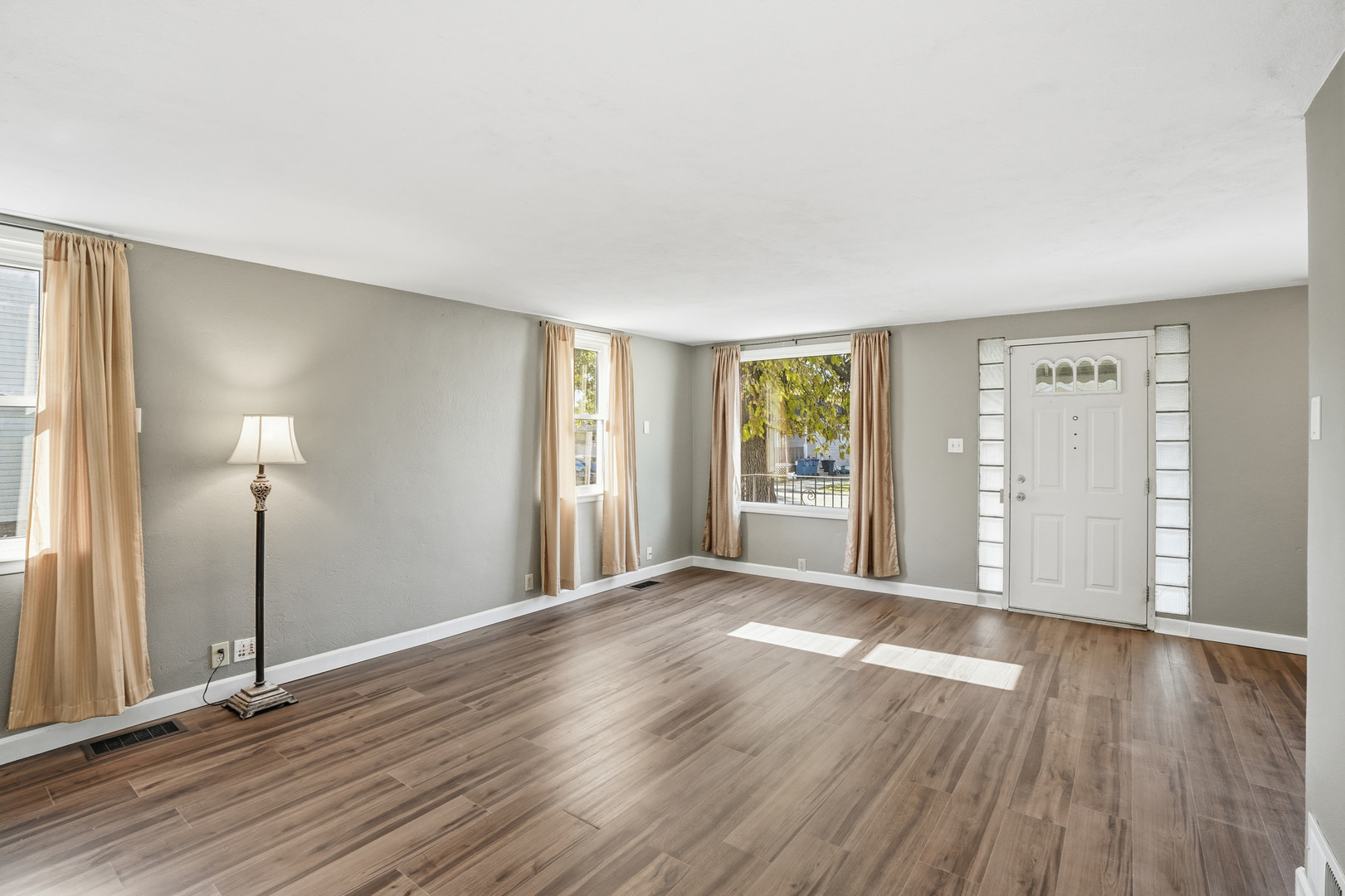 3439 Sangamon Street Steger, IL 60475 - Photo 6 of 25 a view of an empty room with window and wooden floor