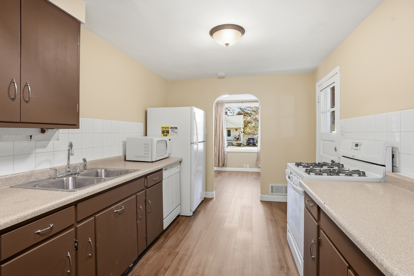 3439 Sangamon Street Steger, IL 60475 - Photo 9 of 25 a kitchen with a sink stove and cabinets