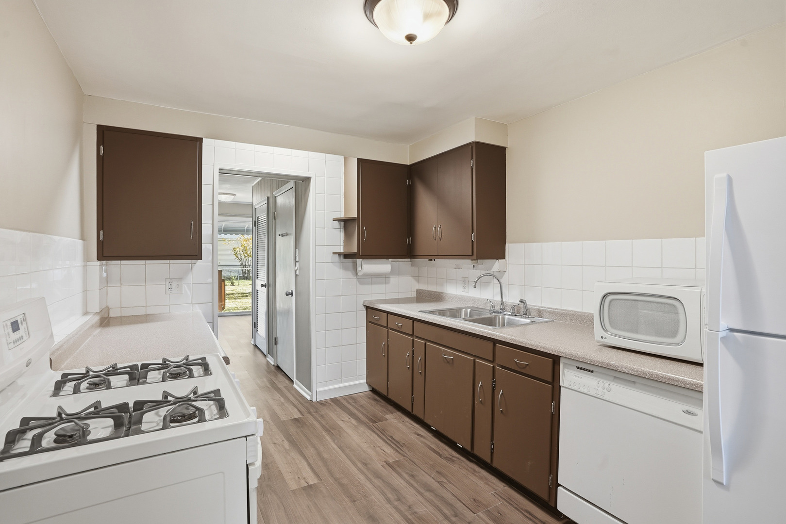 3439 Sangamon Street Steger, IL 60475 - Photo 10 of 25 a kitchen with a sink stove and refrigerator