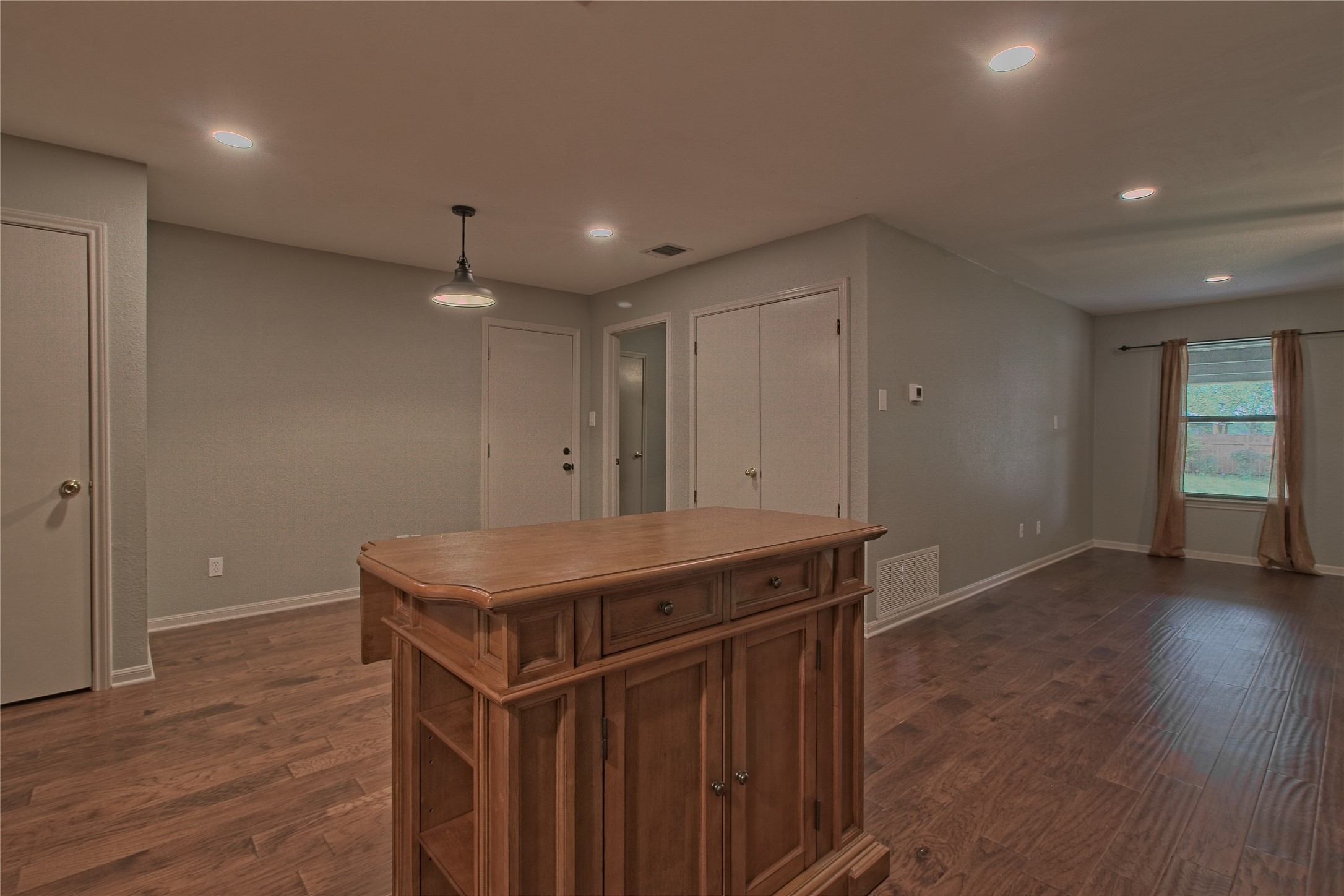 1102 Fowzer Street Taylor, TX 76574 - Photo 11 of 27 Kitchen with dark wood-style flooring, pendant lighting, light countertops, and wood finish cabinets