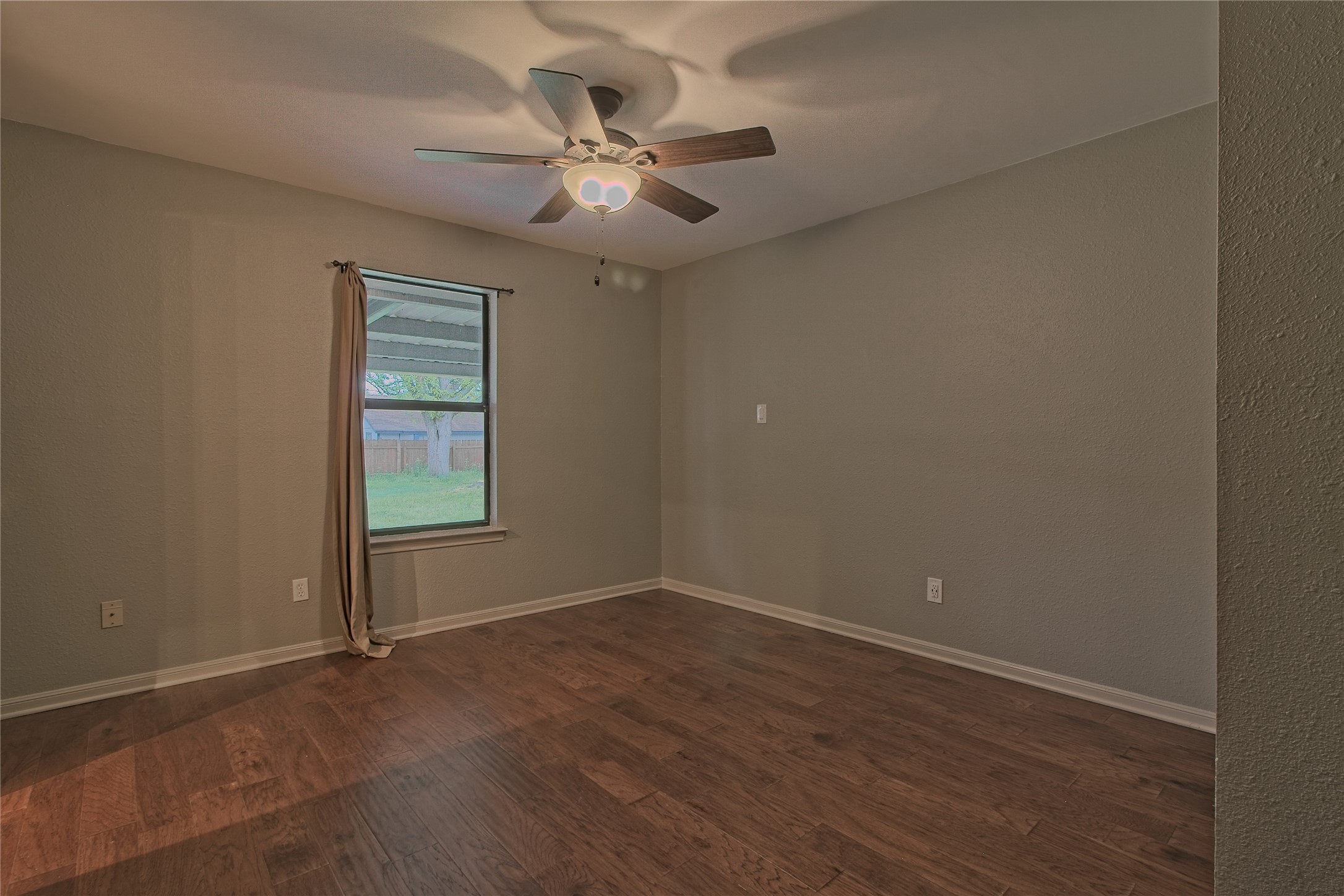1102 Fowzer Street Taylor, TX 76574 - Photo 15 of 27 Spare room with dark wood-style flooring and a ceiling fan