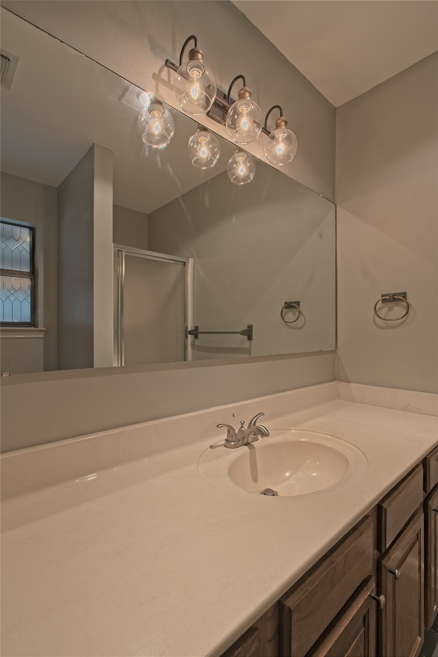 1102 Fowzer Street Taylor, TX 76574 - Photo 17 of 27 Bathroom with vanity and a shower stall