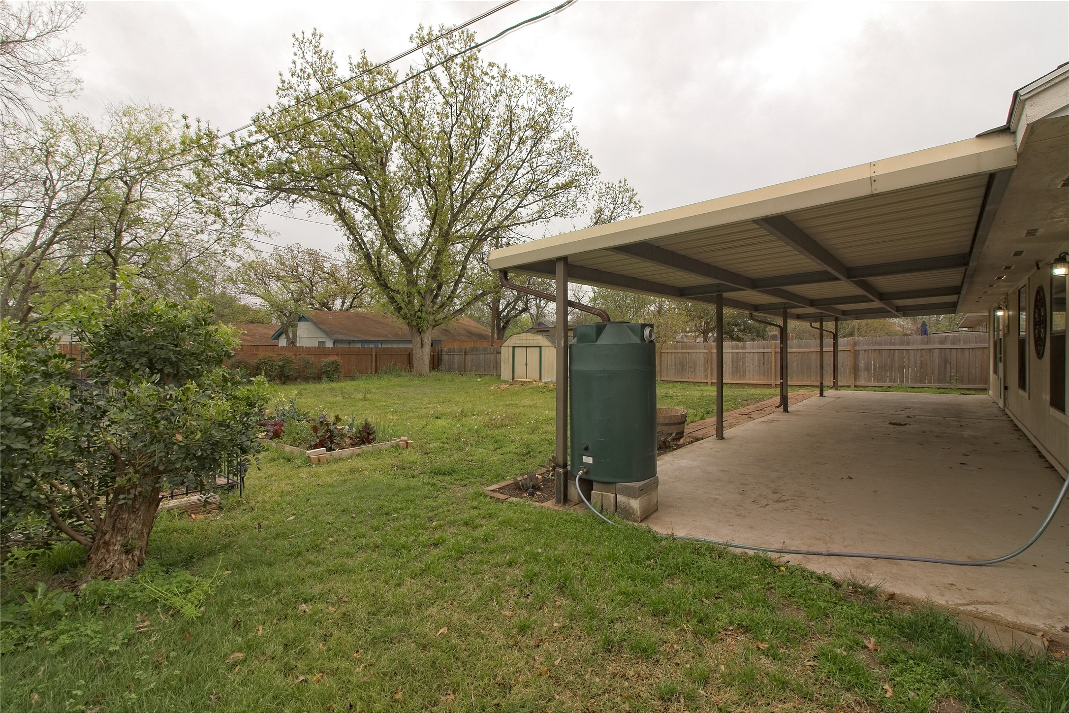 1102 Fowzer Street Taylor, TX 76574 - Photo 22 of 27 Fenced backyard with a patio area and a storage unit
