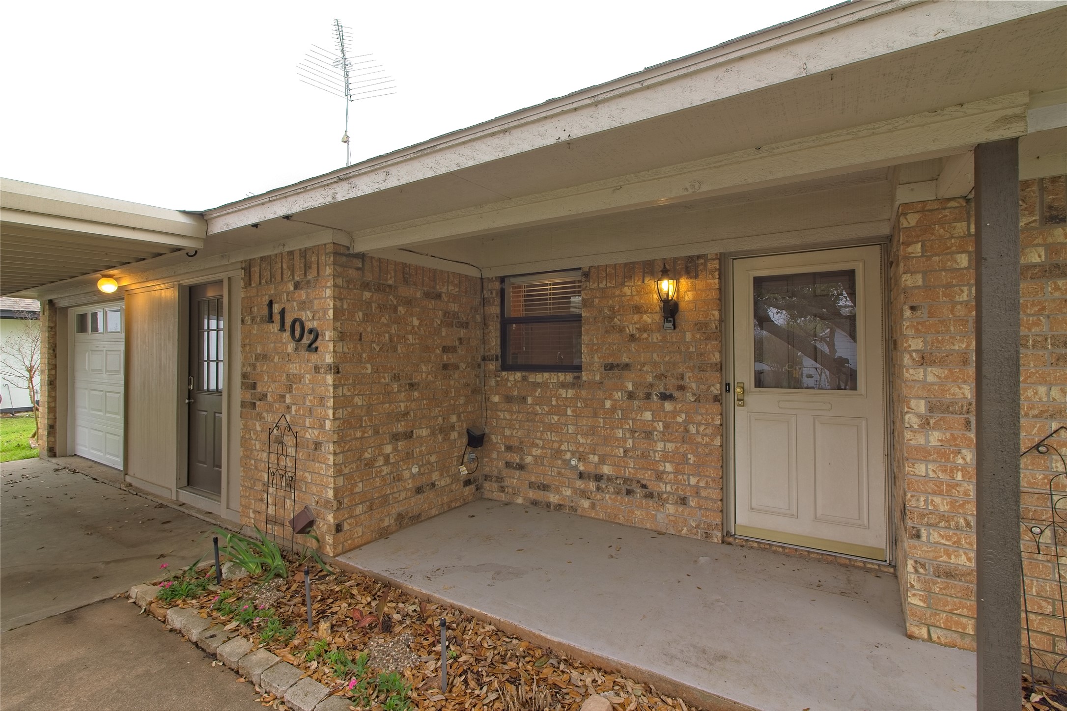1102 Fowzer Street Taylor, TX 76574 - Photo 4 of 27 Property entrance with a patio area and brick siding