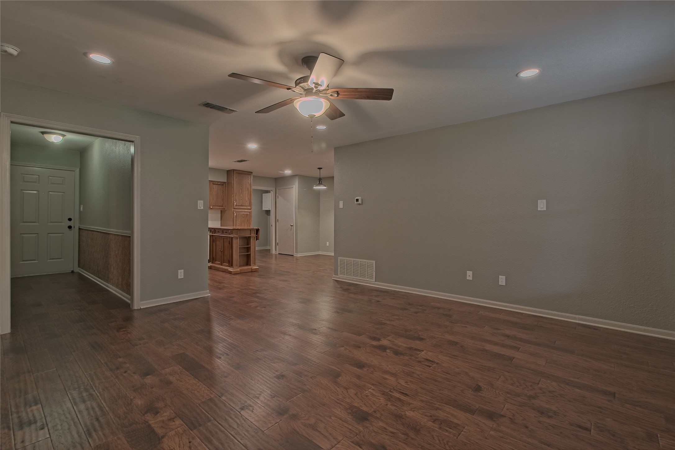 1102 Fowzer Street Taylor, TX 76574 - Photo 5 of 27 Unfurnished room featuring dark wood-style floors, ceiling fan, and recessed lighting