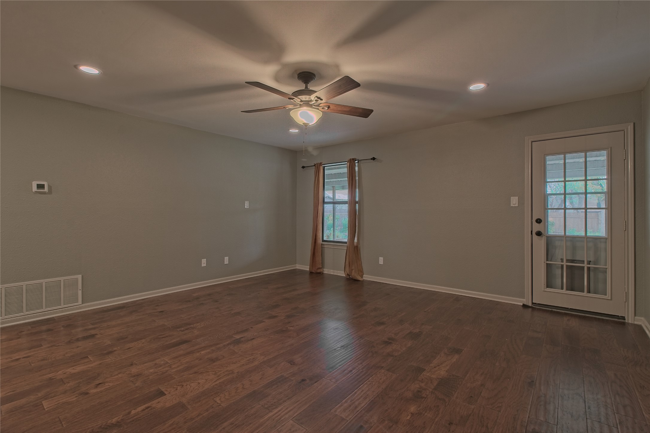 1102 Fowzer Street Taylor, TX 76574 - Photo 6 of 27 Unfurnished room with dark wood finished floors, ceiling fan, and recessed lighting